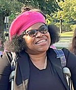 Blanca Martinez, immigrant from Honduras Smiling woman stands with aid of crutches