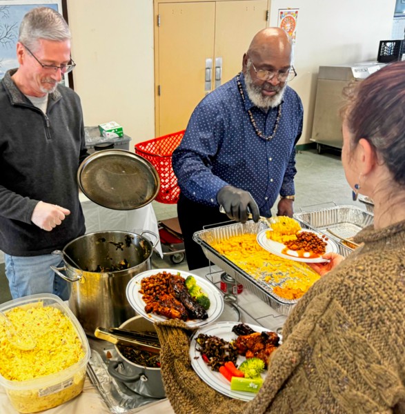2 men serving food
