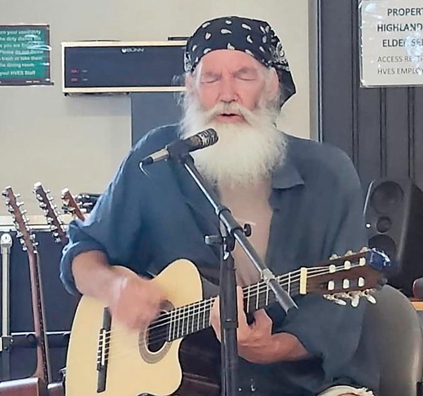 bearded man playing guitar