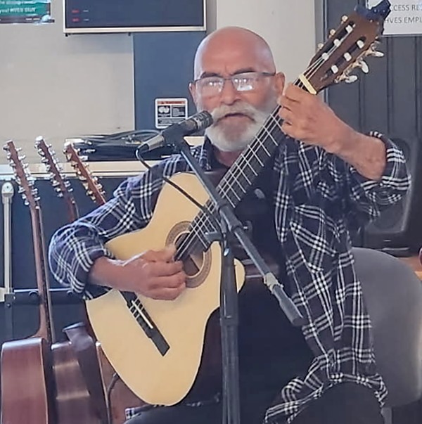 bearded man playing guitar