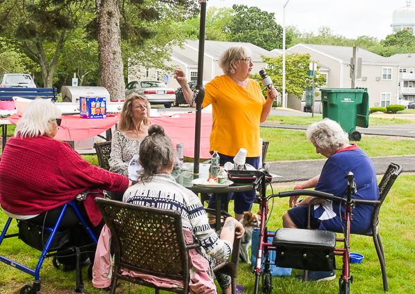 A resident of Apple Village addresses the community.